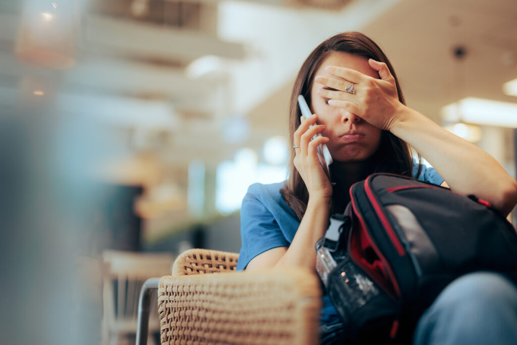 Woman upset on the phone in an airport lounge.